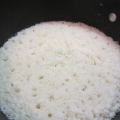 Cook, uncovered, for about 15 to 18 minutes or until all the liquid is absorbed and tiny small holes develop on the surface of the rice.