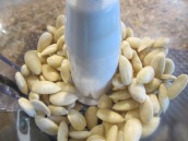 Place almonds into the bowl of a food processor fitted with the metal chopping blade. Process for 2 to 3 minutes or until finely ground.